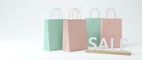 Pastel pink and mint green shopping bags with sale sign on white background, perfect for retail, fashion, and seasonal promotion concepts.