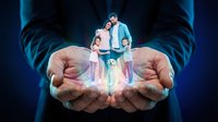Protective hands holding miniature family with glowing light effect symbolizing care, insurance, security and guardianship concept on dark background.
