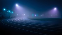 Athletic running track with dramatic stadium lighting and fog creating moody sports atmosphere for competitions and training events.