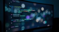Programming code on computer screen with colorful syntax highlighting and bokeh lights background for software development projects.