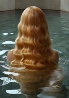 Young woman with long blonde wavy hair shown from behind, submerged in dark turquoise water creating artistic reflection and mysterious atmosphere.