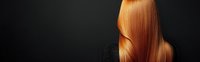 Smooth, shiny copper red hair flowing against dark background, showcasing healthy straight locks for beauty and haircare advertising.