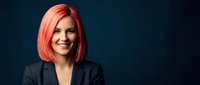 Professional businesswoman with vibrant pink hair smiling confidently in dark suit jacket against navy background for corporate branding and leadership concepts.