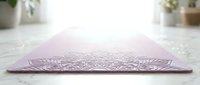 Lavender yoga mat with intricate mandala design on white surface, ready for fitness, meditation, and wellness studio use.