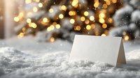 Blank greeting card on snow with festive bokeh lights from Christmas tree in background, perfect for holiday messages and winter celebrations.