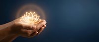Hands holding glowing lotus flower symbol representing spirituality, wellness, meditation, and inner peace against dark blue background for mindfulness concepts.