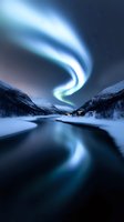 Spectacular aurora borealis swirling over snowy mountain valley with frozen river reflecting northern lights in winter landscape for nature photography.