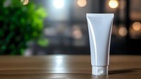 White cosmetic tube on wooden surface with blurred bokeh lights background for skincare and beauty product mockup design.