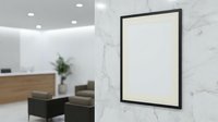 Modern office interior with blank white poster frame on marble wall for mockup presentation and branding display in professional workspace environment.