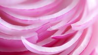 Delicate pink petals create flowing curves and layers in soft macro photography, revealing intricate natural patterns and textures in romantic pastel tones.
