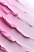 Pink frosting texture with diagonal swirls and ridges creates abstract pattern. Creamy surface shows detailed peaks and valleys in pastel tones for bakery designs.