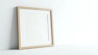 Minimalist wooden picture frame with white mat leaning against wall, perfect mockup template for artwork display and interior design presentations.