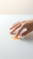 Hand touching glowing golden star on white surface, representing success, achievement, rating, and customer satisfaction for business concepts.