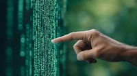 Human hand pointing at digital matrix code on virtual screen, green binary data stream background with bokeh effect. Technology and cybersecurity concept.