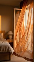 Warm sunlight streams through sheer orange curtains in a cozy bedroom with wooden furniture and a made bed, creating a serene morning atmosphere for home decor and lifestyle content.