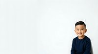 Young boy, approximately 6-8 years old, East Asian ethnicity, wearing dark navy blue long-sleeve shirt, isolated on white background, suitable for educational materials, family websites, and children's product design.