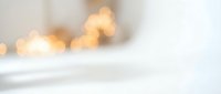 Soft blurred warm golden lights creating dreamy bokeh effect on white background for elegant design projects and romantic atmosphere concepts.