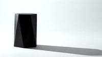 Black geometric book or tablet standing upright casting shadow on white surface, modern minimalist design for technology and digital media concepts.