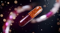Glowing medical capsule with sparkles floating in dark space against blurred bokeh background, pharmaceutical and healthcare concept.