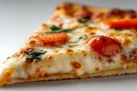 Fresh baked pizza slice with melted mozzarella cheese, cherry tomatoes and herbs on white background. Italian cuisine comfort food for restaurant menu.