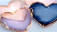 Pink and navy blue heart shapes with gold edges and glitter sparkles on light background, romantic valentines day design elements for greeting cards and decor.