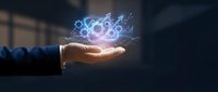 Businessman hand holding glowing atom symbol with digital particles, representing science, technology, innovation, and atomic energy research for corporate and educational use.