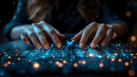Female hands typing on illuminated keyboard with blue light effects and glowing particles, creating magical technology atmosphere for digital transformation concept.