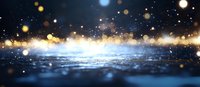 Magical glowing particles floating over reflective wet surface with bokeh lights and sparkles creating dreamy atmospheric night scene. Blue and gold colors blend.