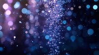 Magical sparkles and bokeh lights creating dreamy atmosphere with purple and blue glowing particles floating in dark space, abstract background for festive designs.