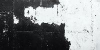 Abstract black and white textured wall surface with peeling paint and rough concrete showing contrast between dark and light areas.