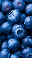 Fresh ripe blueberries with natural bloom coating in macro view showing detailed texture and deep blue color. For food packaging and healthy eating concepts.