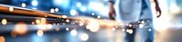 Sparks flying from metal grinding process with blurred bokeh lights and motion blur effect in industrial workshop setting. Metalworking background.