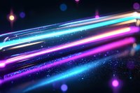 Vibrant neon light trails with glowing particles against dark background create dynamic motion effect, featuring blue, pink and purple streaks for modern designs.