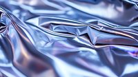 Shiny metallic blue foil surface with wrinkles and folds creating abstract reflective texture for luxury packaging or modern background design.