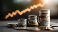 Stacked coins with upward trending arrow chart in background representing financial growth, investment success, and wealth building concepts.