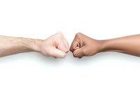 Multiracial fist bump between light and dark-skinned arms showing unity, friendship, and solidarity against white background, isolated horizontal composition.