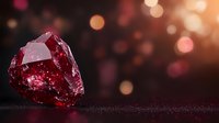 Raw ruby crystal on dark background with magical bokeh lights and glitter. Natural gemstone macro photography showcases deep red color and crystalline structure.