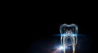 Glowing tooth cross-section with internal root structure illuminated in blue light against dark background, suitable for dental education, healthcare marketing, and dentistry presentations.