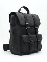 Black leather backpack with multiple compartments and buckle closures, isolated on white background. Vintage-style travel bag suitable for business, casual wear, and outdoor adventures.