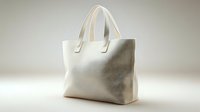 Elegant cream leather handbag with dual handles on neutral background for fashion and accessories design projects.