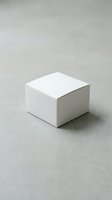 White blank cardboard box mockup on gray concrete surface, ready for branding and packaging design presentation.
