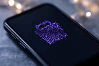 Glowing purple gift box icon on smartphone screen with bokeh lights in background, modern digital shopping concept for mobile apps and e-commerce.
