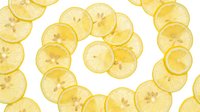 Bright yellow lemon slices arranged in a spiral pattern on a white background, isolated and ready for design use in food and health projects.