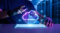 Businessman hands protecting glowing cloud computing network with digital icons above tablet in modern data center for technology solutions.