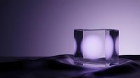 Transparent glass cube with glowing light inside on dark reflective surface against purple gradient background, suitable for product display and design projects.