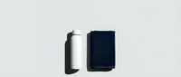 Rolled black and navy blue towels isolated on white background, ready for spa, hospitality, and wellness design projects.