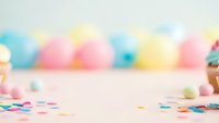 Colorful party celebration background with confetti scattered on pink surface and blurred balloons creating festive atmosphere for events and holidays.