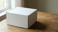White cardboard shipping box on wooden table near window with natural light for e-commerce packaging and delivery services.