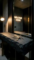 Modern entryway with keys on a dark stone shelf, mirror reflecting a glowing neon welcome home sign, moody interior design concept.