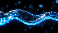 Glowing blue wave of sparkling particles flowing on black background with bokeh lights creates magical atmosphere for technology presentations.